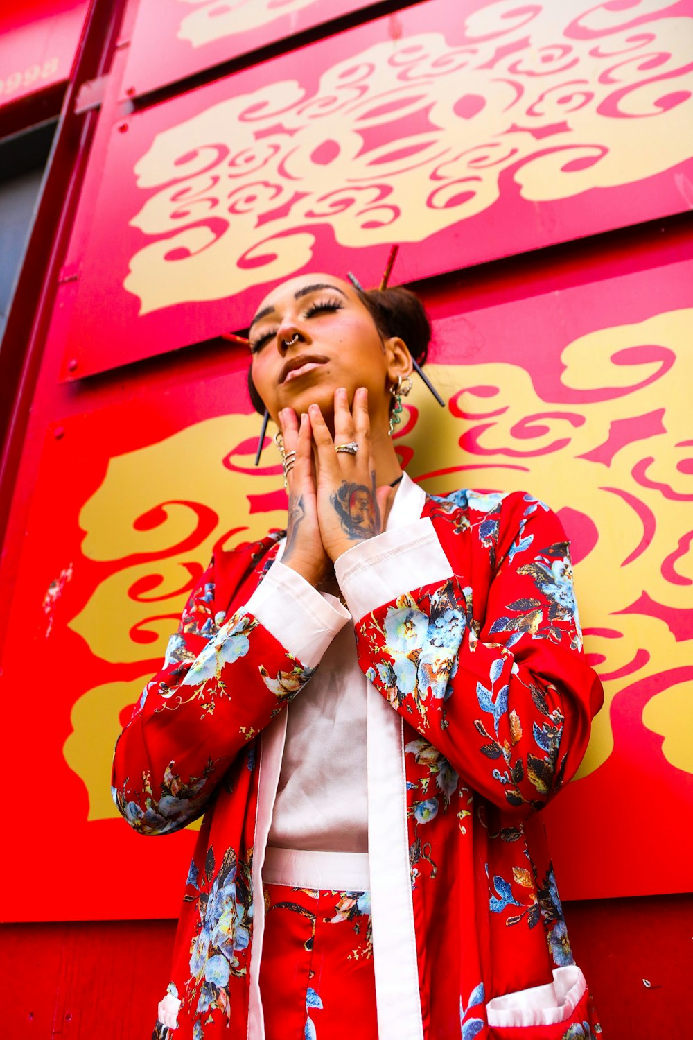 woman wearing red and blue floral long-sleeved coat