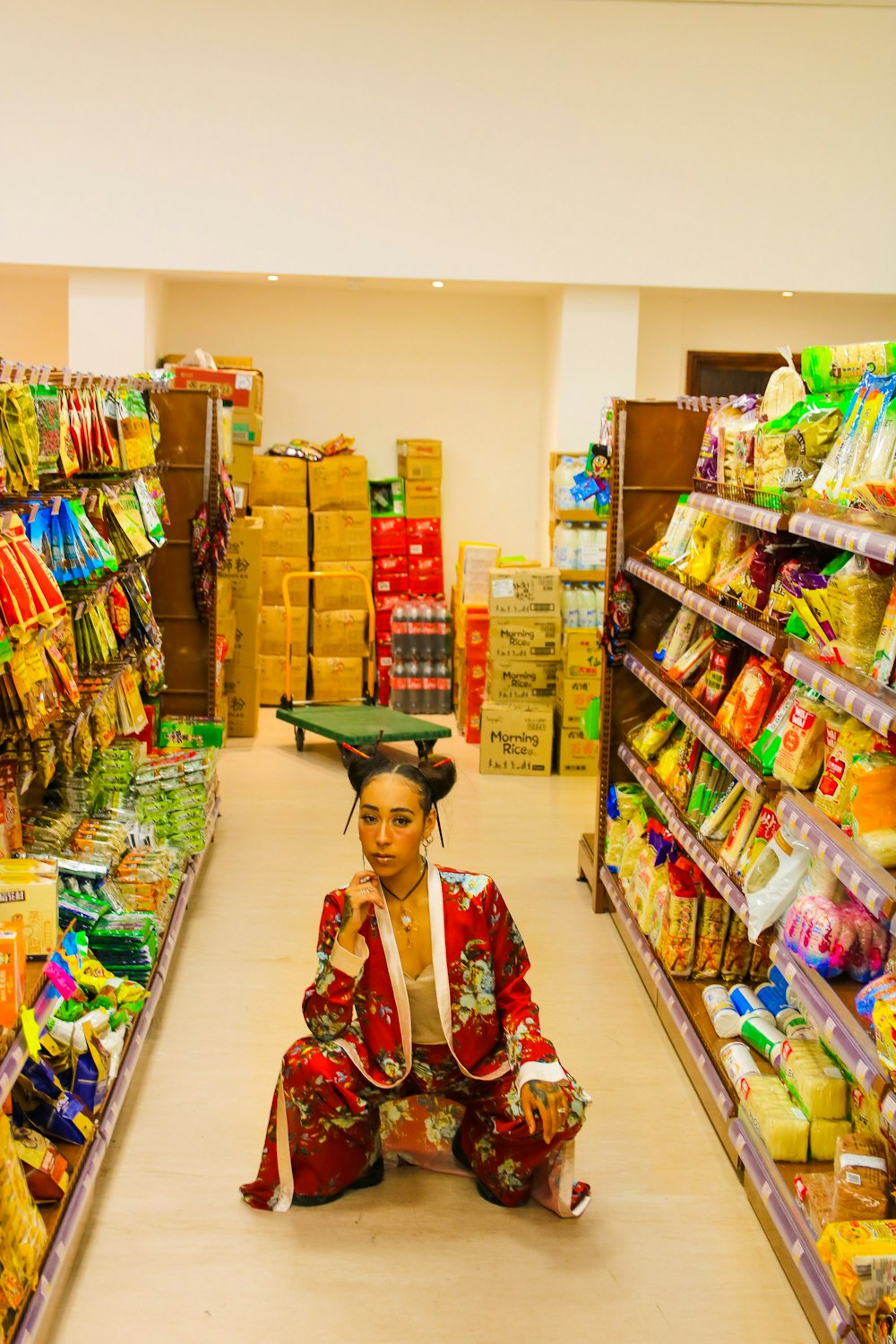 woman squatting on the floor inside the store