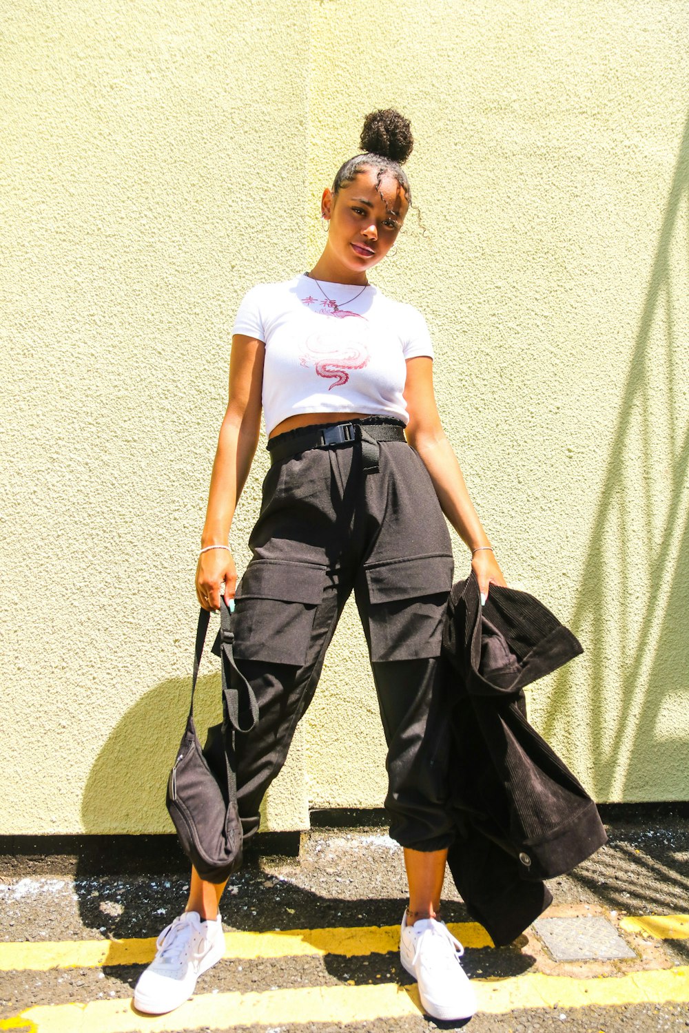 woman wearing white shirt and black pants