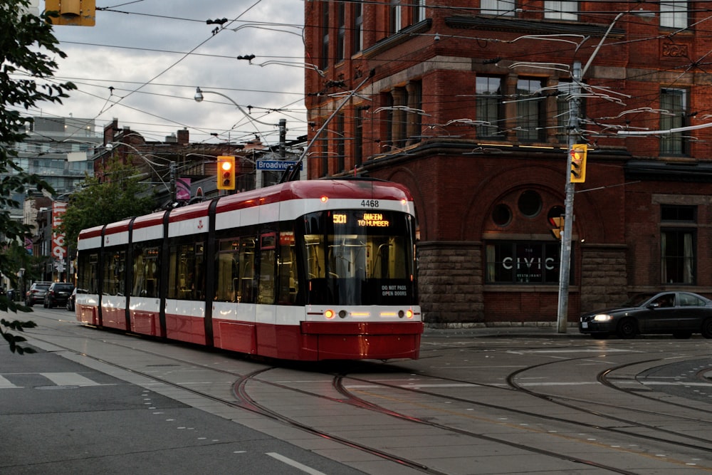 white and red train at daytime