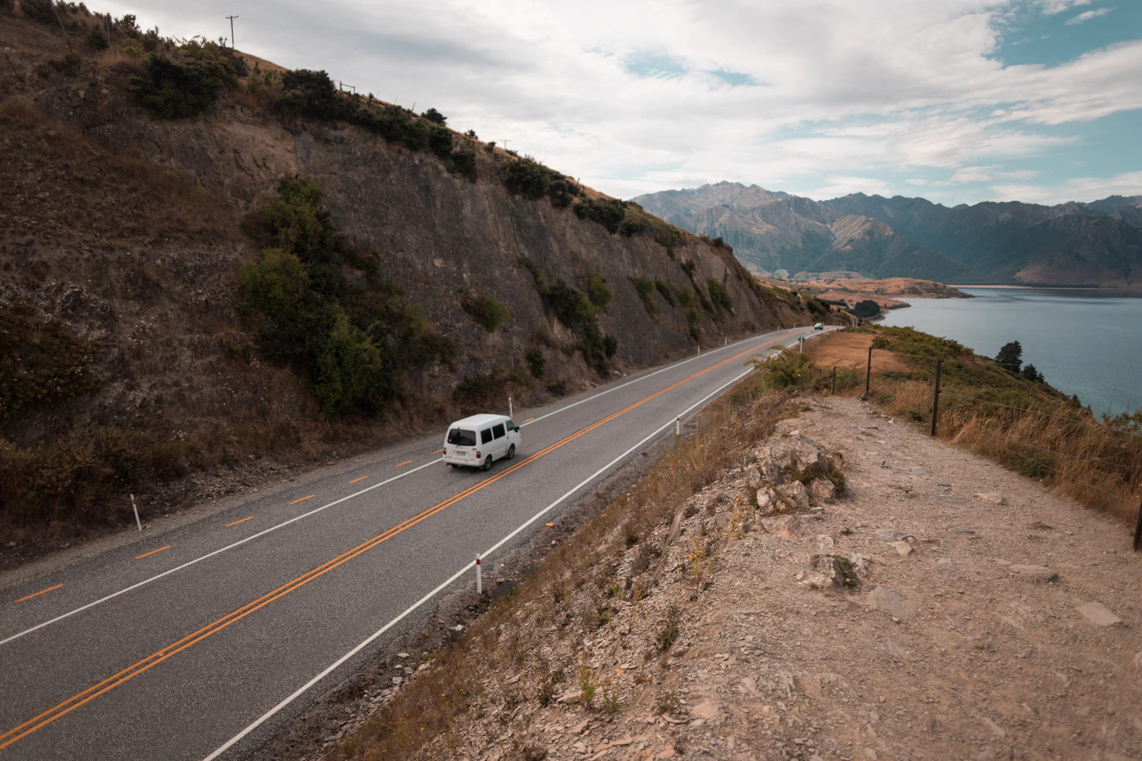 Campervan traveling beside a lake in New Zealand