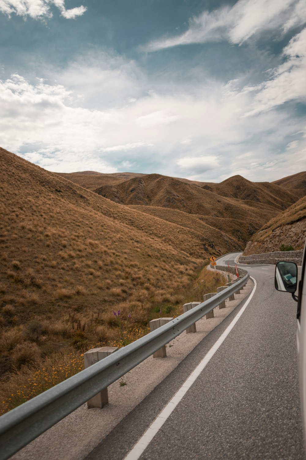 vehicle on road between mountain at daytime