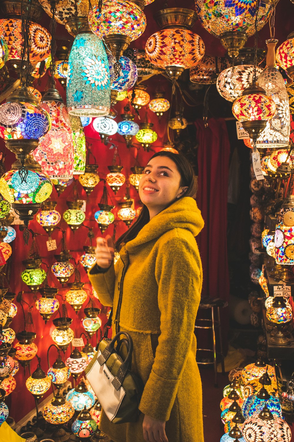 woman looking at pendant lamps
