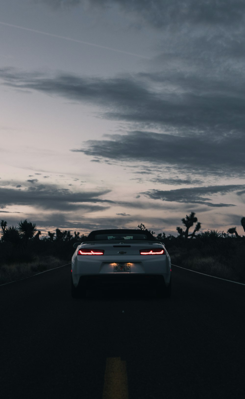 white car under cloudy sky