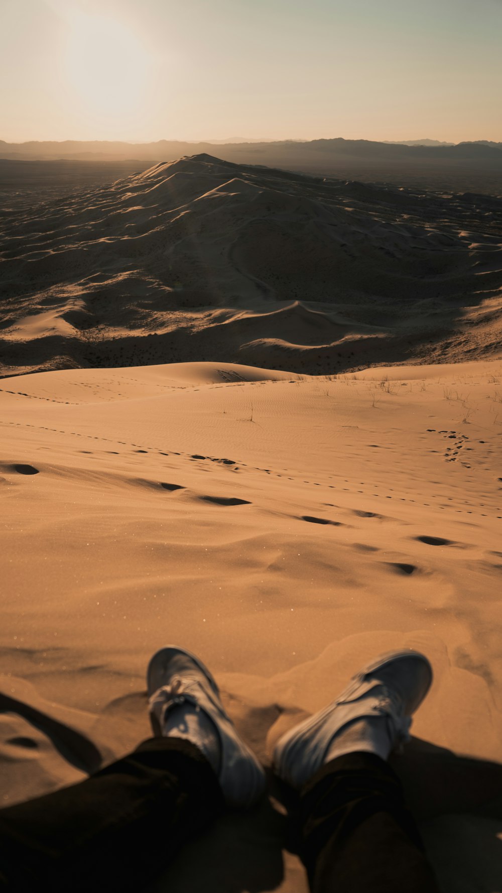 person sitting on desert during day