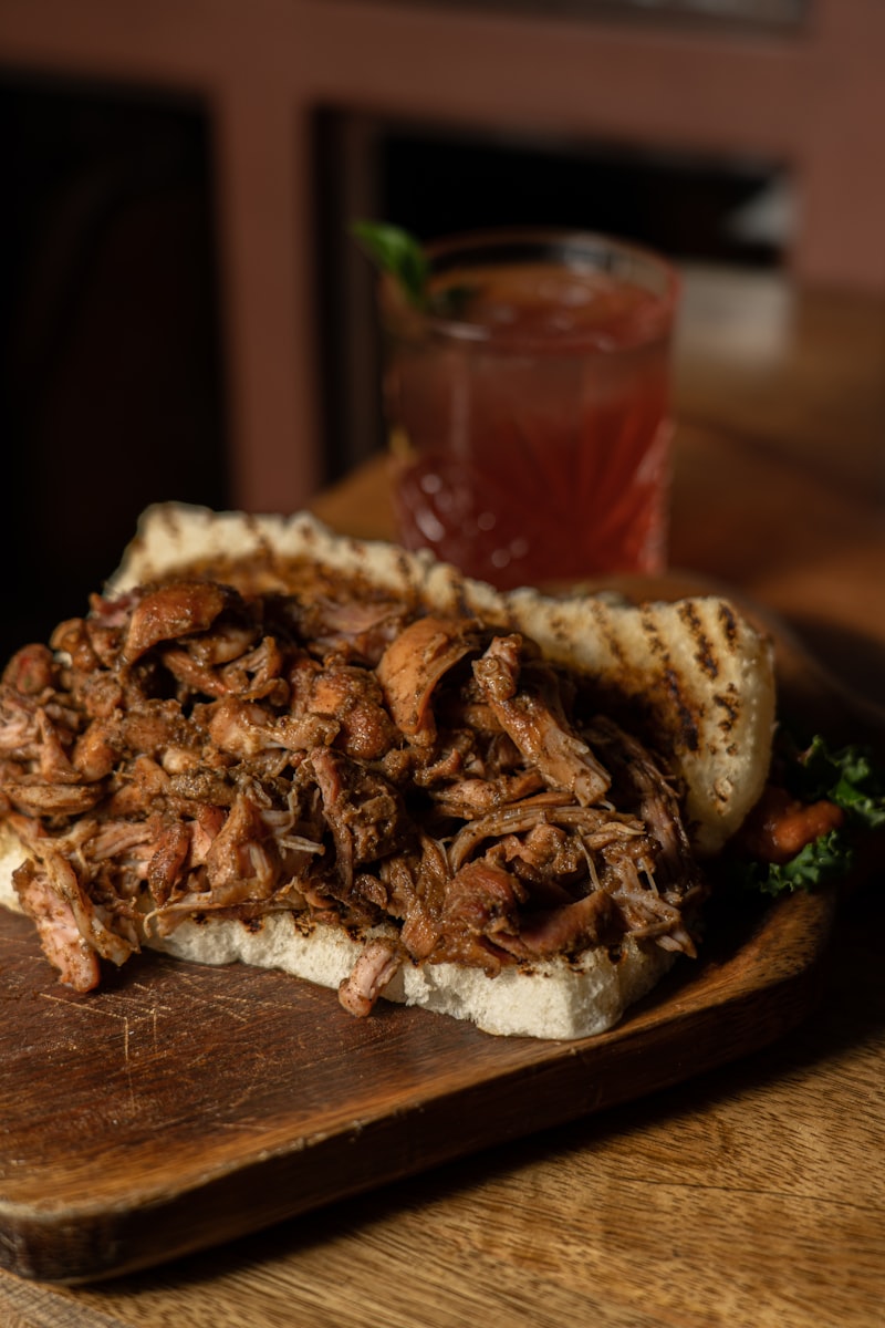 Pile of shredded pulled pork on a wooden board