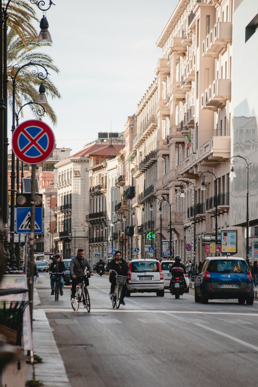 cars and people on road near buildings