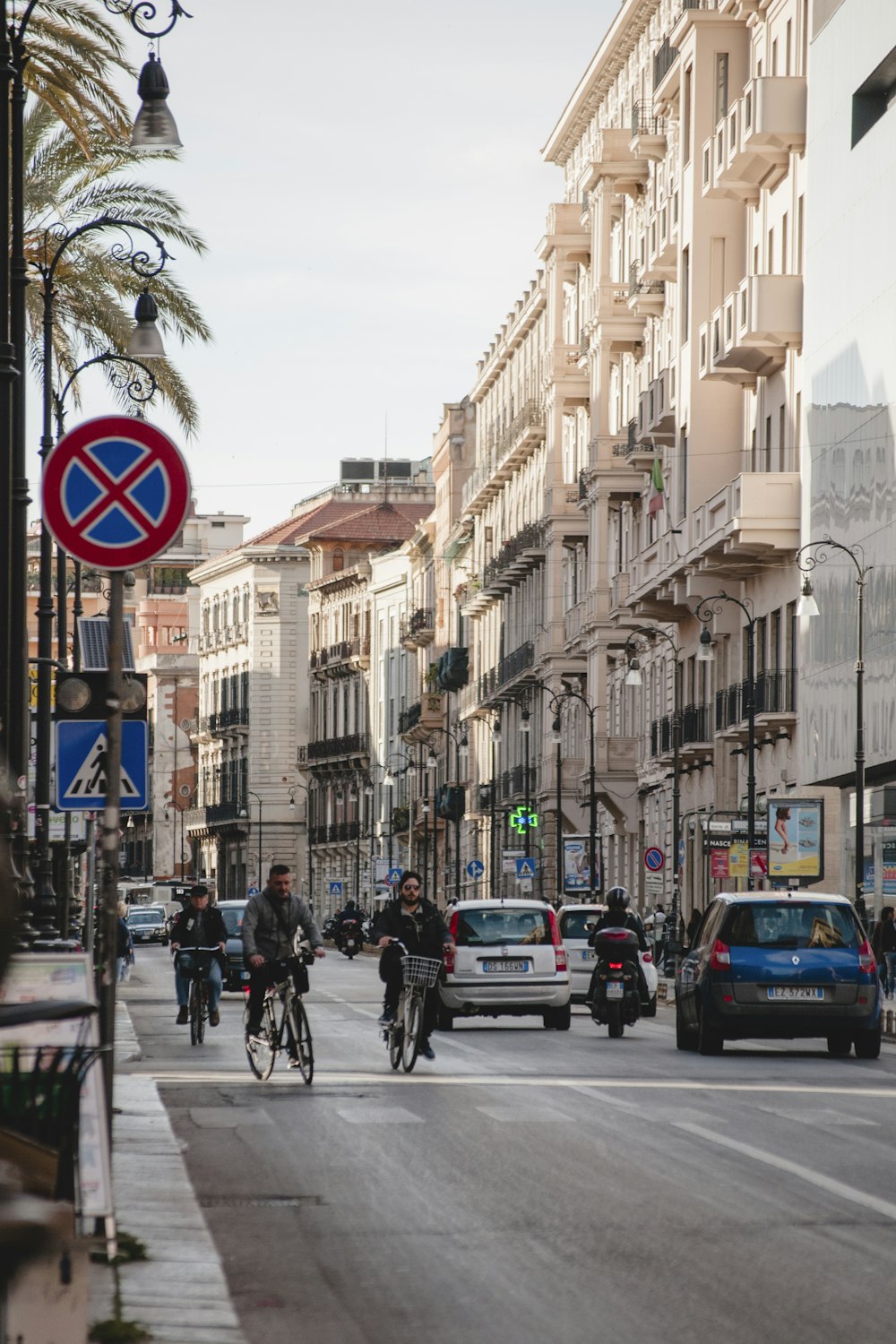 cars and people on road near buildings