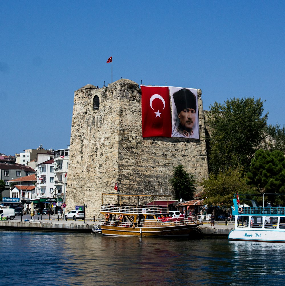 banner of Mustafa Kemal Ataturk hanging from a gray concrete building