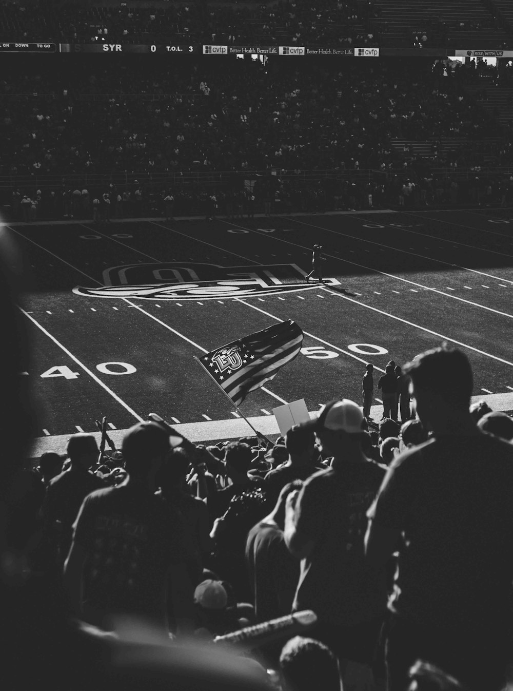 grayscale photography of a football stadium filled with people