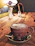 A cozy corner of Lotuscafe AI with warm lighting and a steaming cup of coffee on a sleek table.