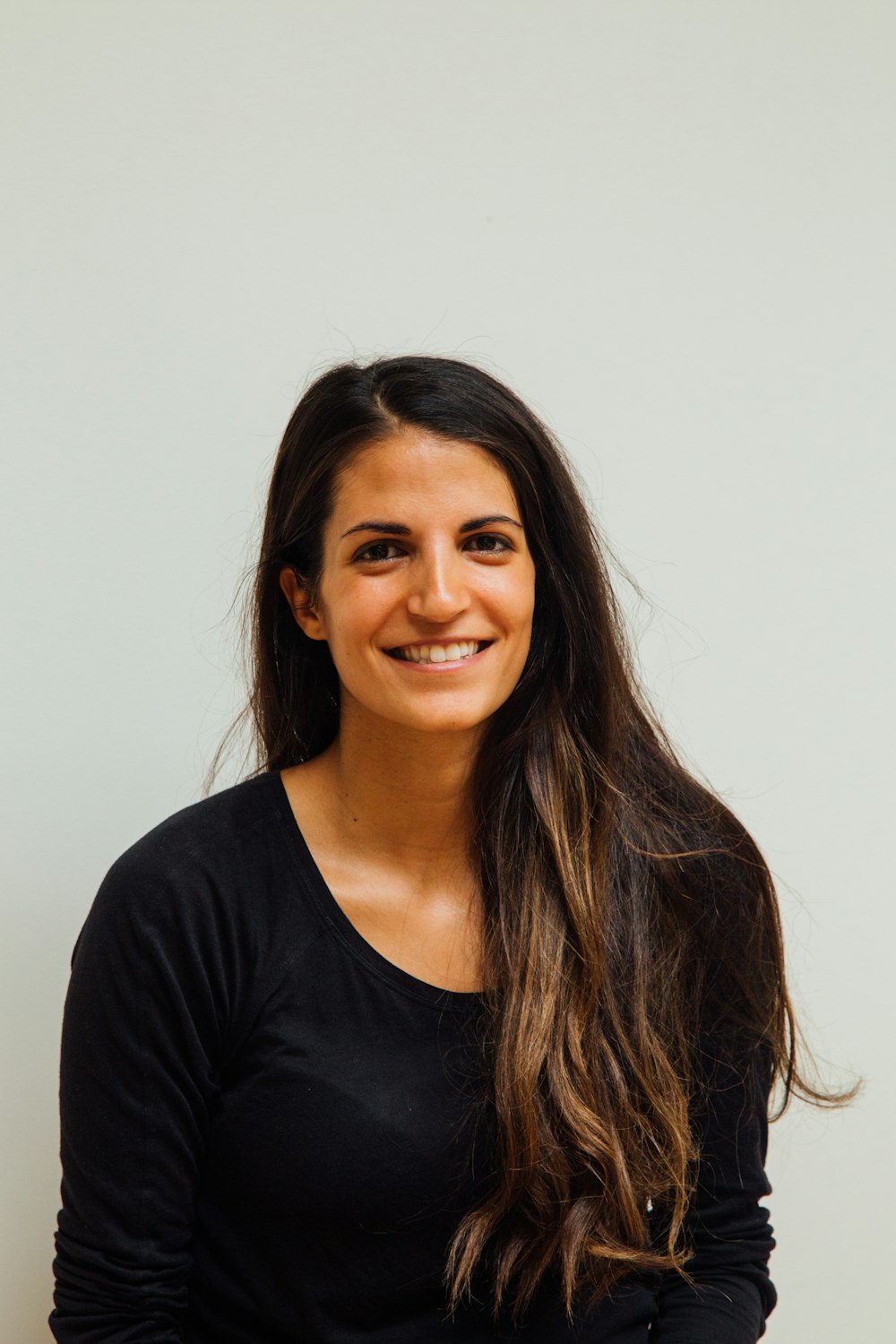 woman wearing black scoop-neck long-sleeved shirt