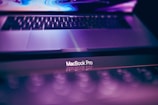 Close-up of a sleek Apple MacBook with the Blueberry Tech logo reflected on the screen.
