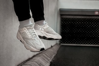 person in black pants and white shoes