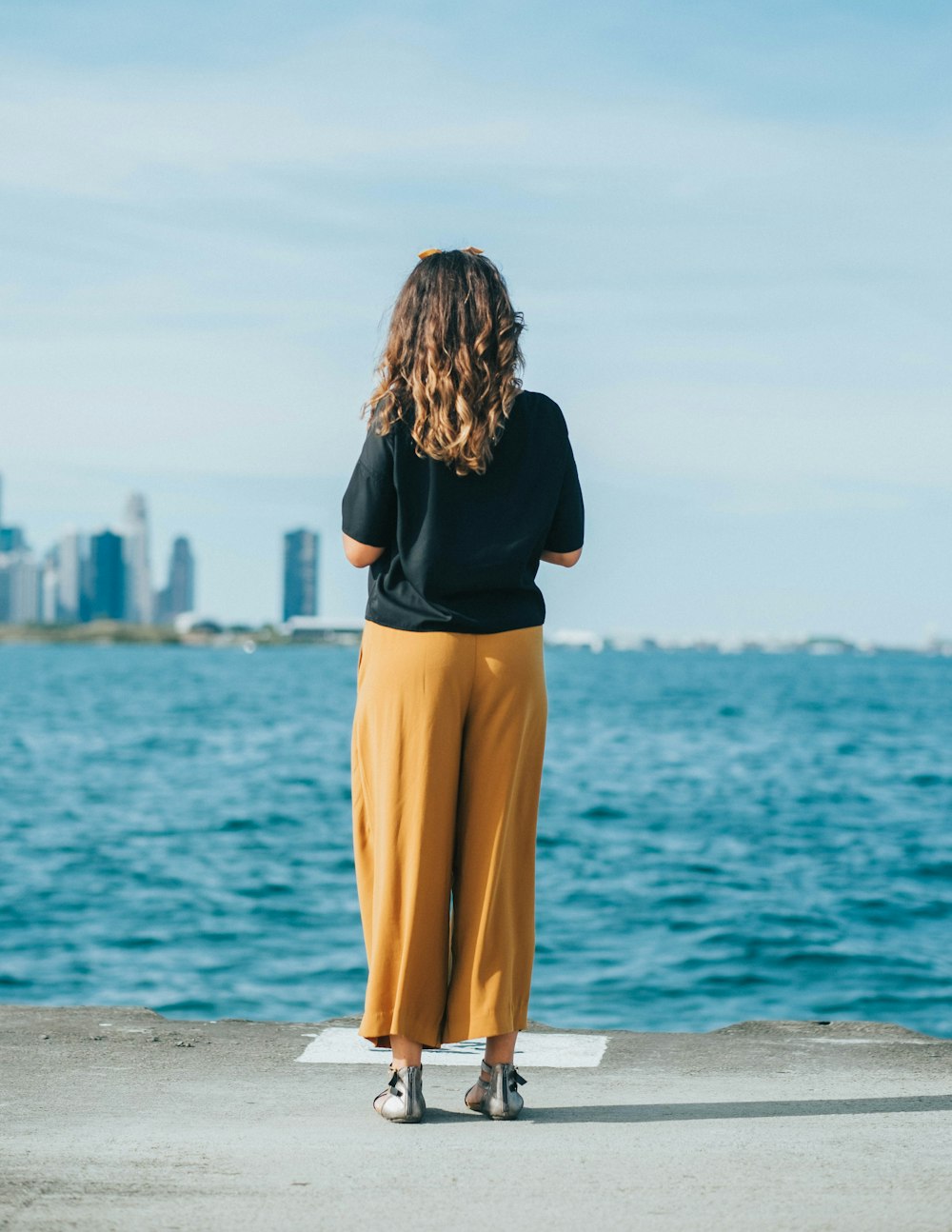 selective focus photography of woman wearing black top and brown pants