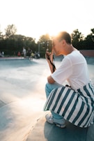 Participants capturing skateboarding moments with cameras during a photography class.