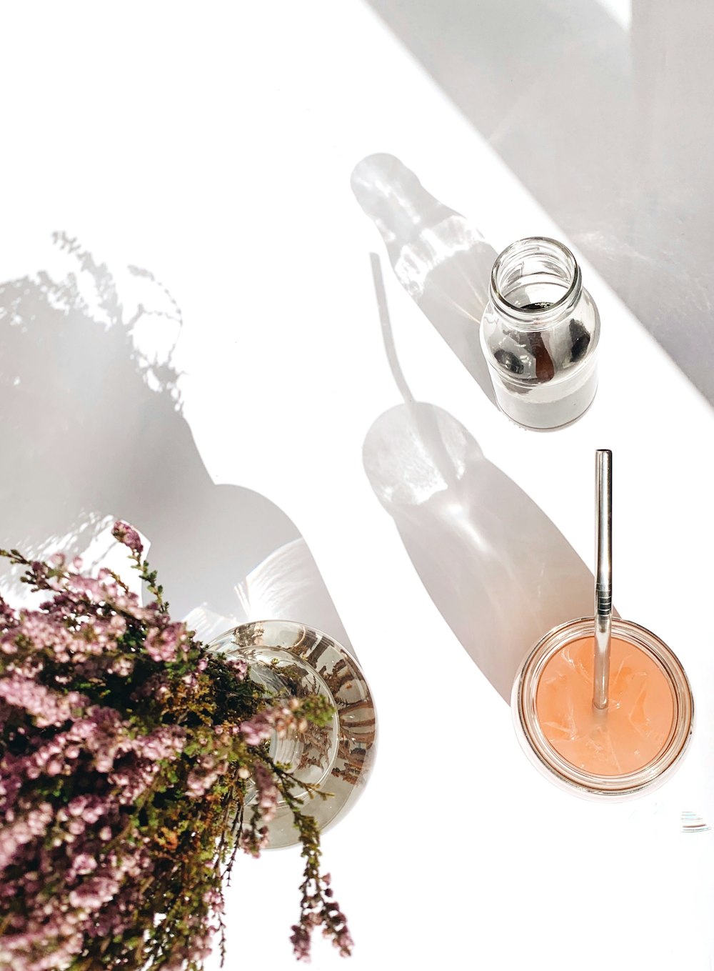 a white table topped with a vase filled with flowers