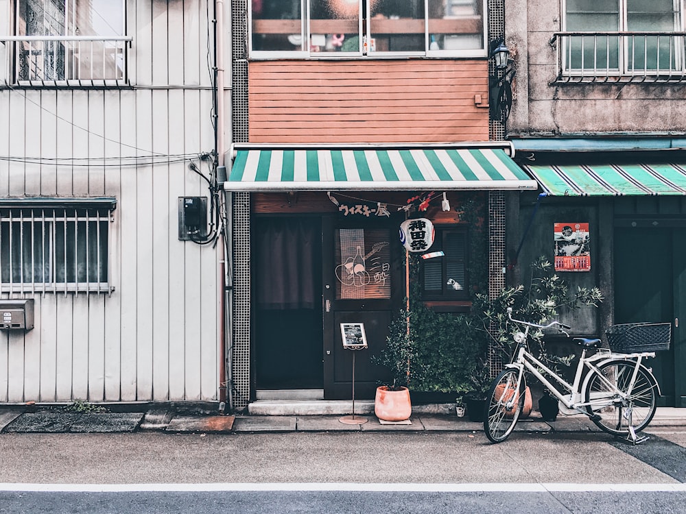 bicycle parked in front of a store