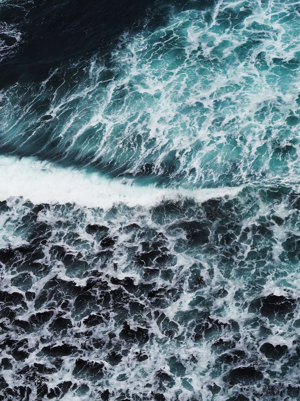 a person riding a surfboard on a wave in the ocean