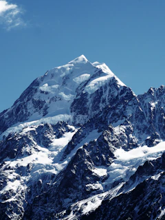 snowy mountain under a calm blue sky during daytime