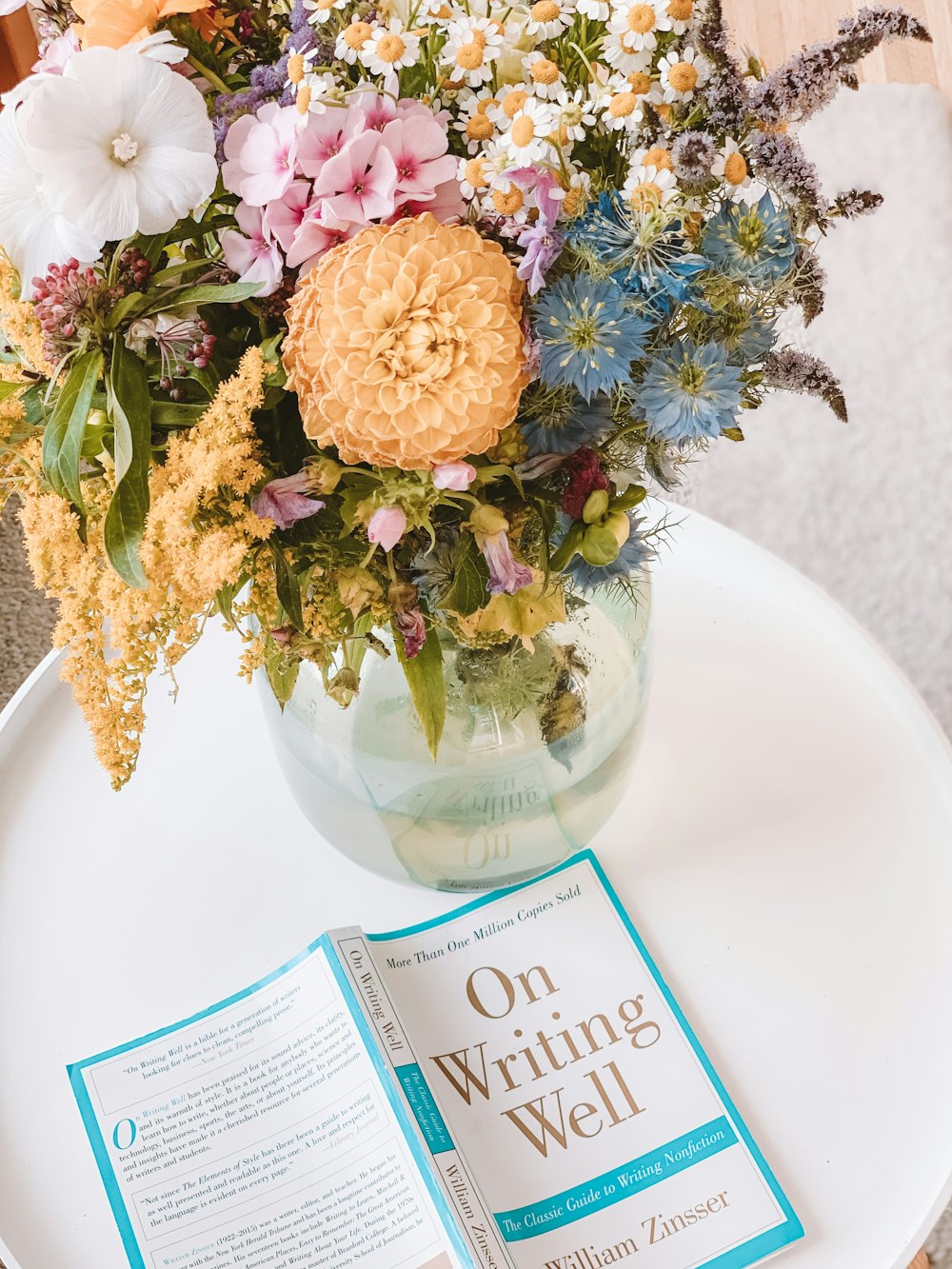 On Writing Well book beside a flower centerpiece