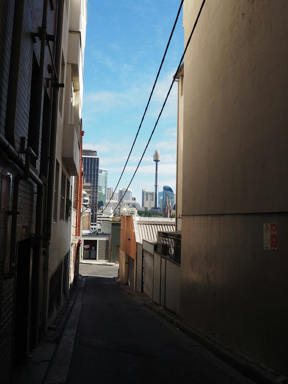 a narrow alley way with buildings in the background