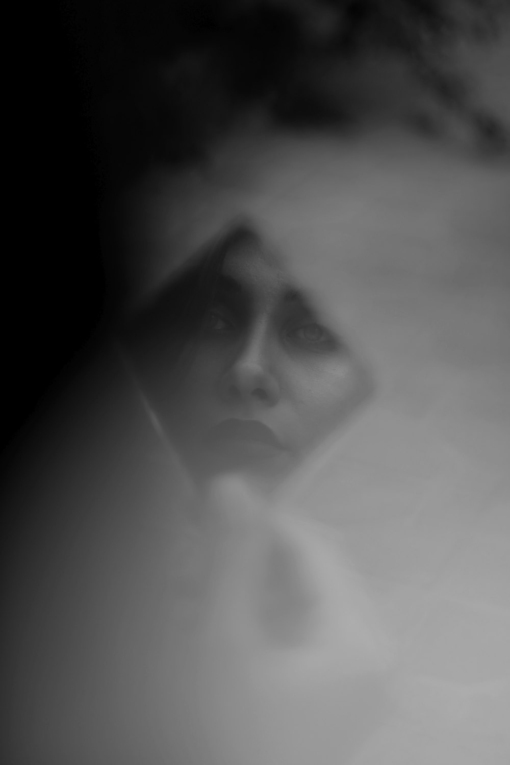 a blurry photo of a woman's face in a mirror