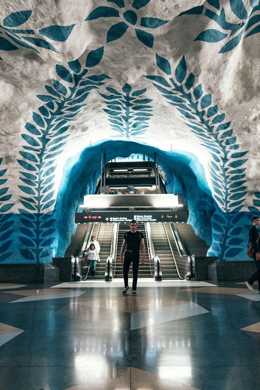 man standing front of escalator