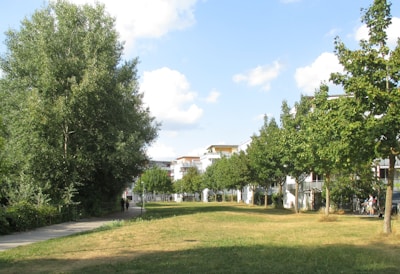 Residents walking along the winding green pathways framed by flowering plants.