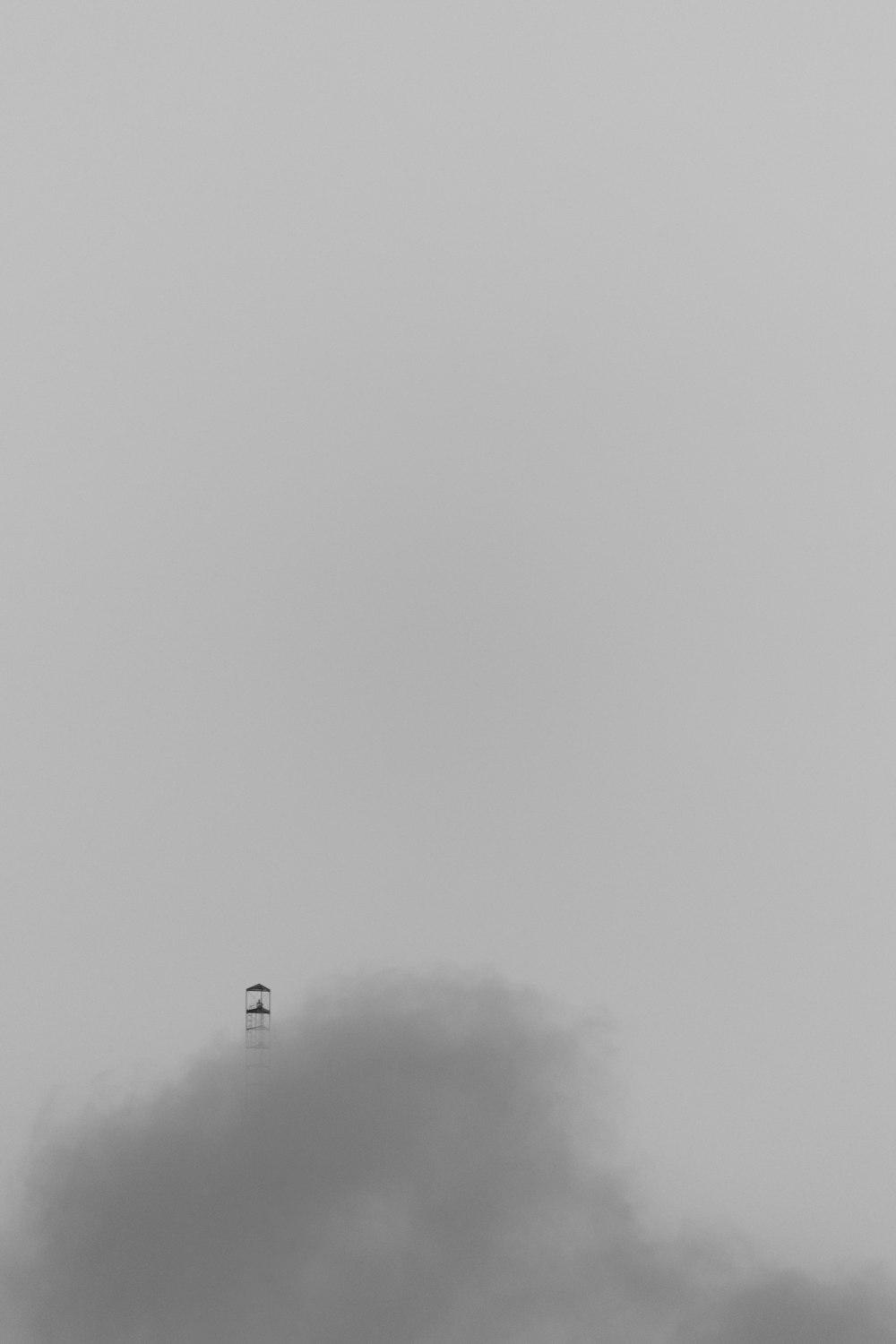 a black and white photo of a plane flying in the sky