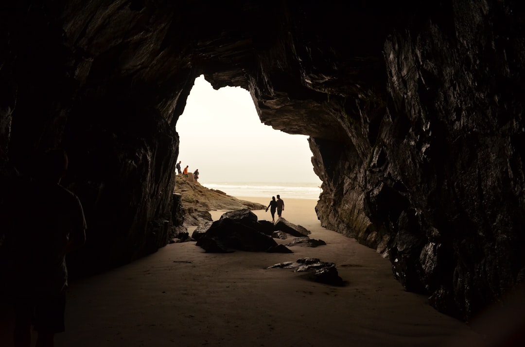 two person walking on shore