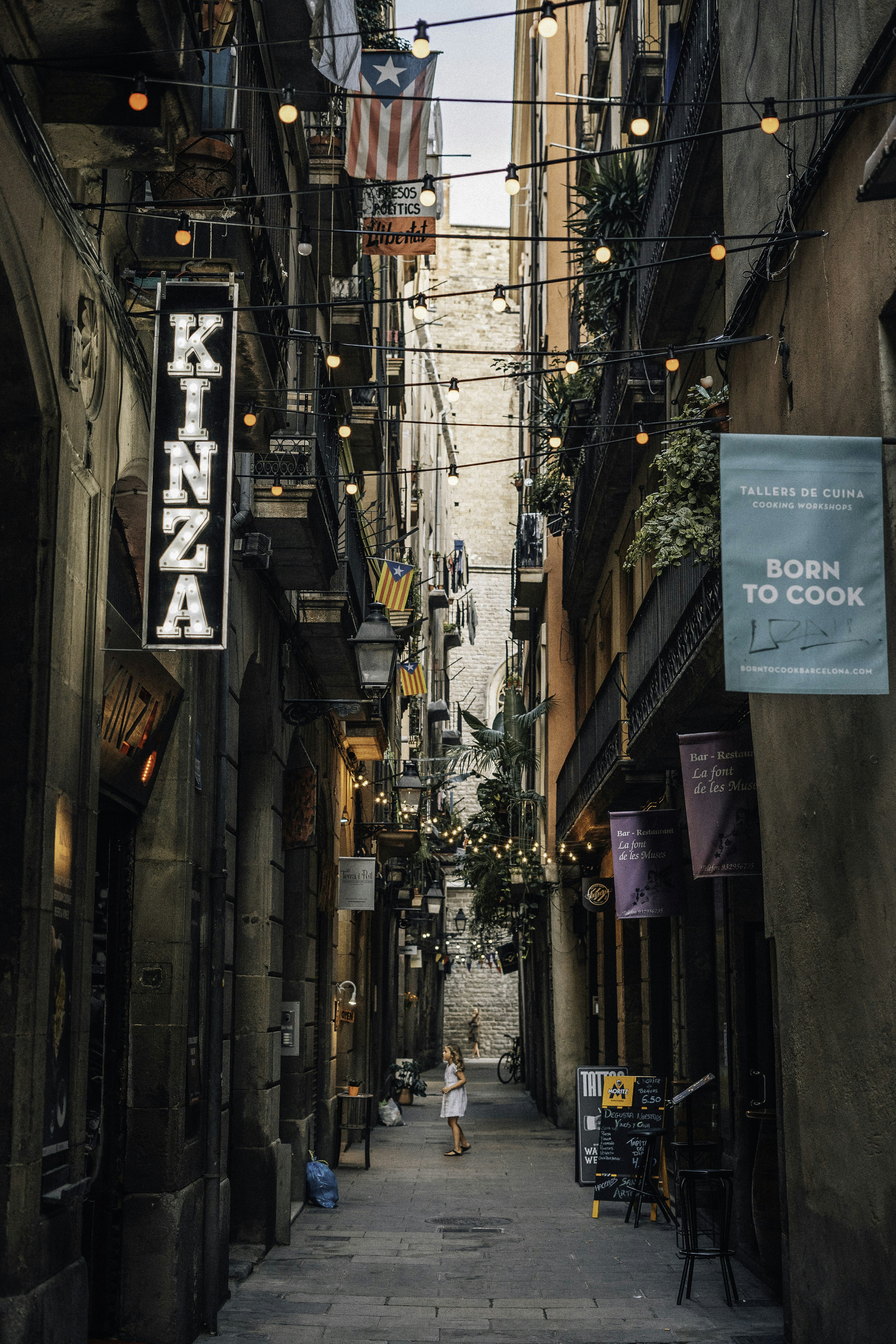 girl stands between alley