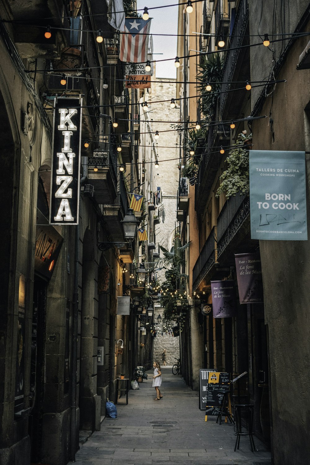 girl stands between alley