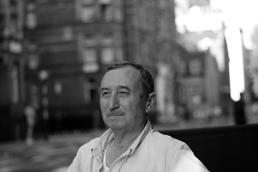 grayscale photo of man in collared top