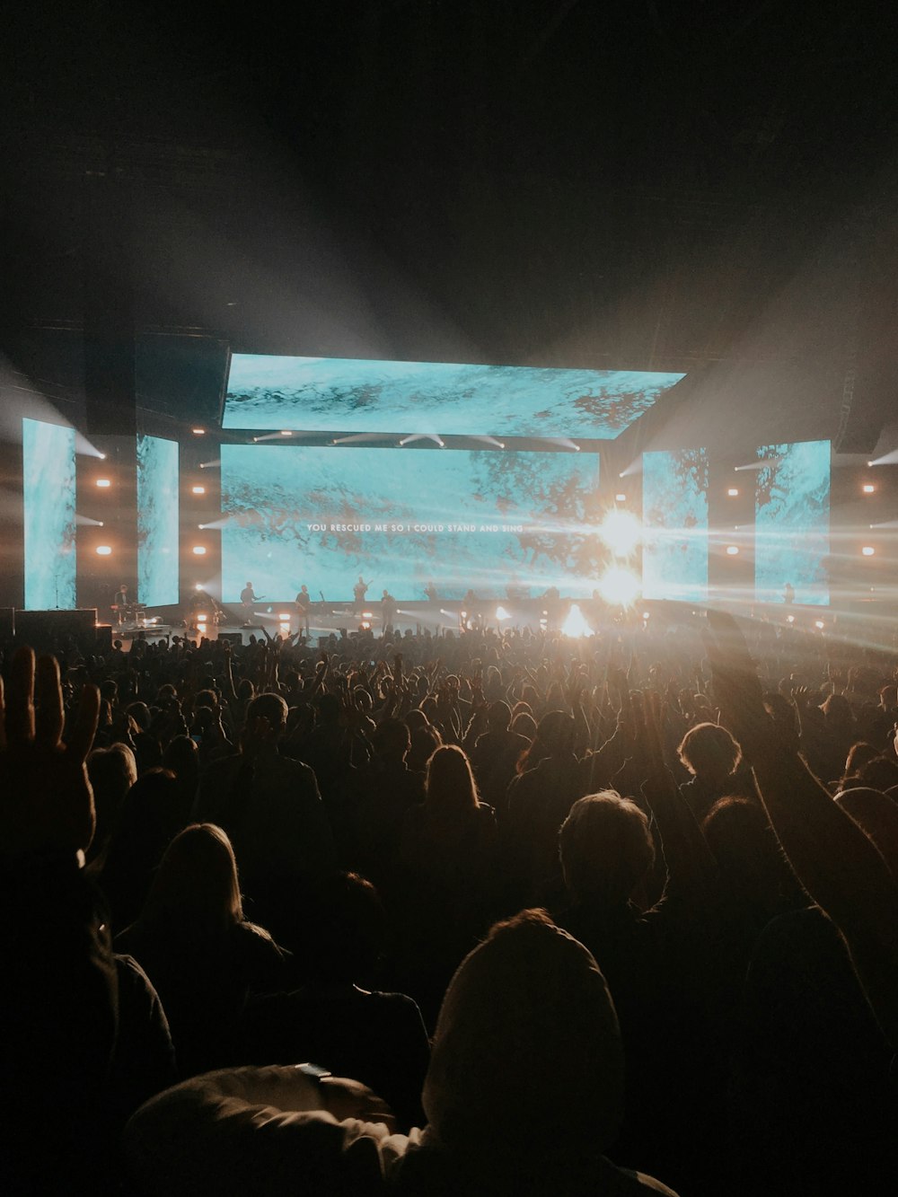 a crowd of people watching a concert on stage