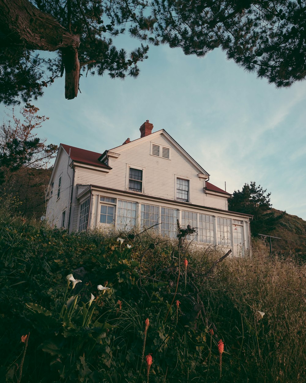 two storey house with attic behind hill