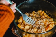 person holding fork getting food