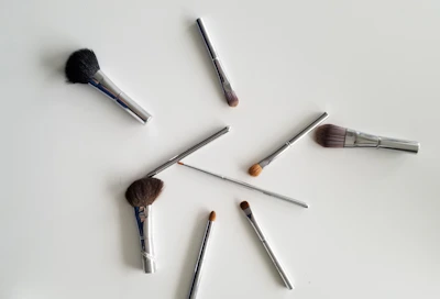 A vibrant palette of professional makeup brushes arranged neatly on a marble surface.