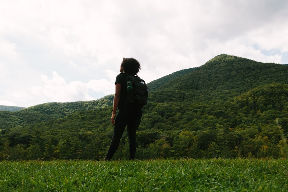 person standing on green grass field during daytime