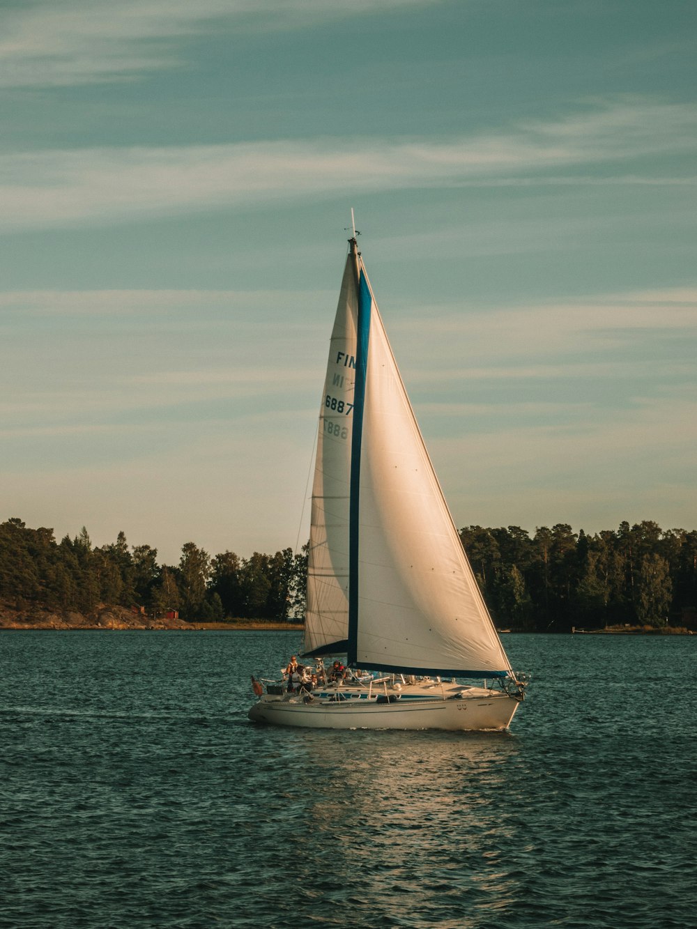 white boat sailing in the sea