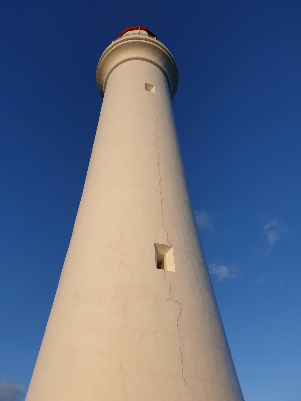 white painted lighthouse during daytime