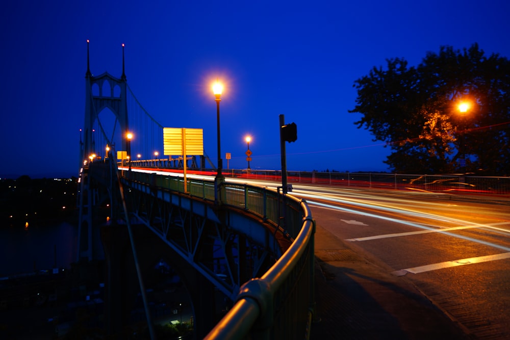 a night time view of a bridge and street lights