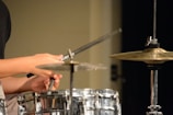 Close-up of hands playing percussion instruments with passion and energy.