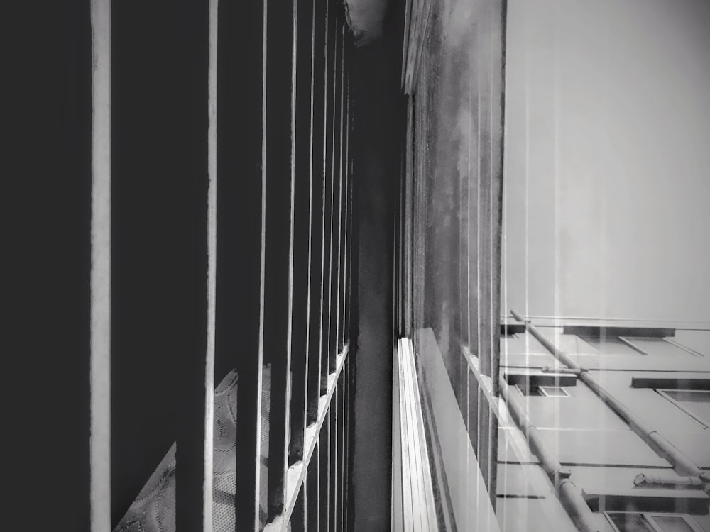 a black and white photo of a window with bars