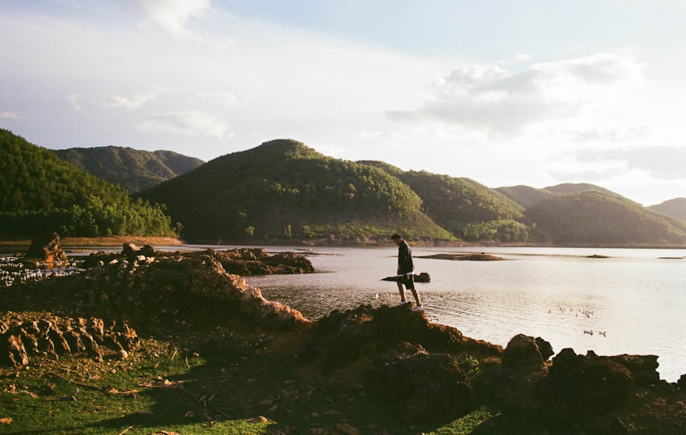 person standing near body of water during daytime