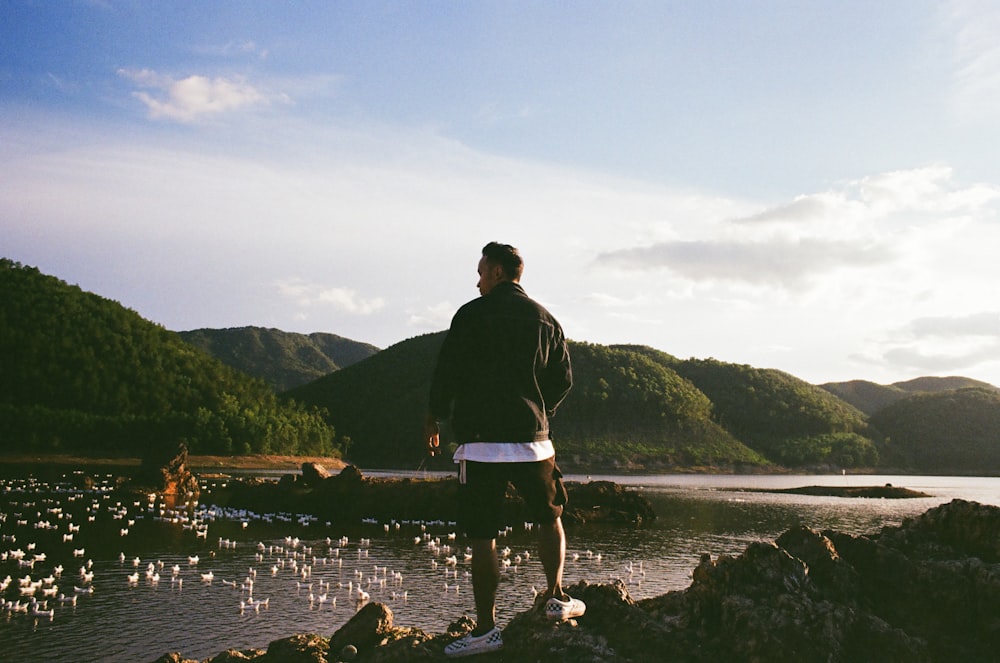 man standing near flock of bird