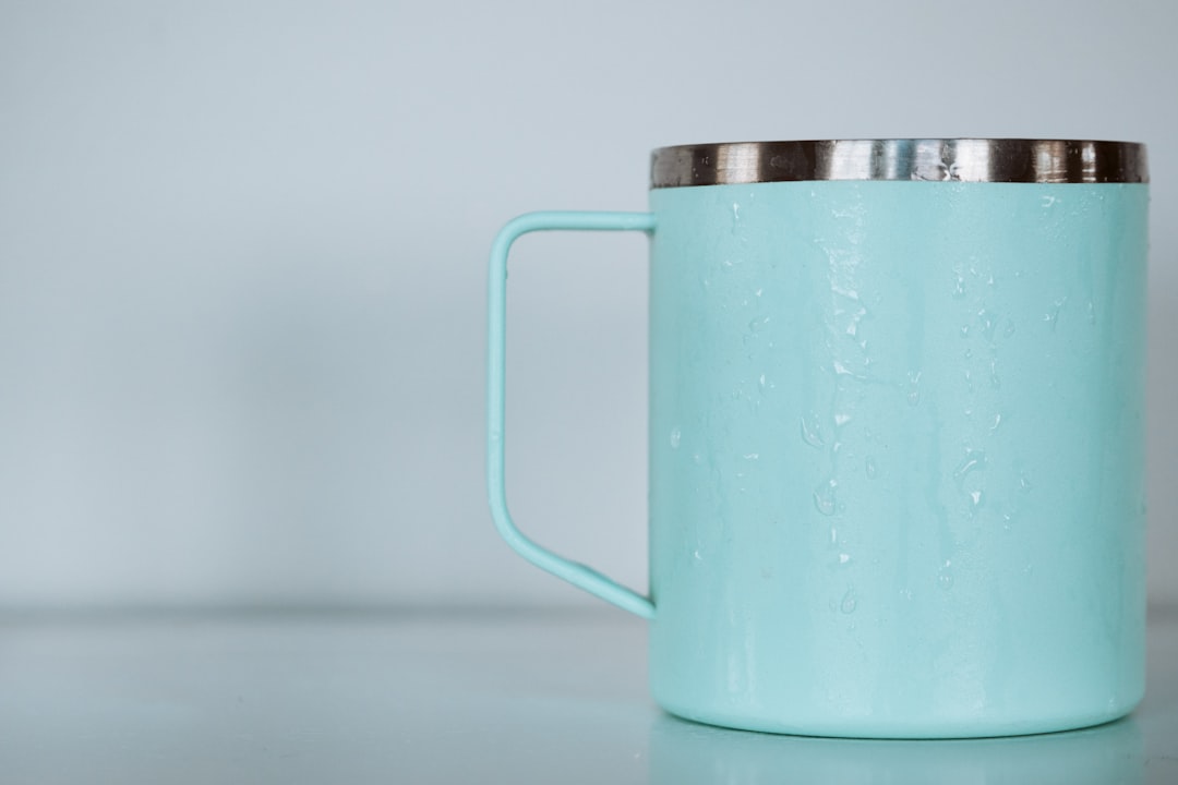 shallow focus photo of teal mug