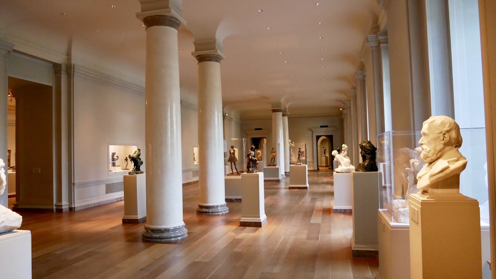 empty hallway of building with headbust on stand