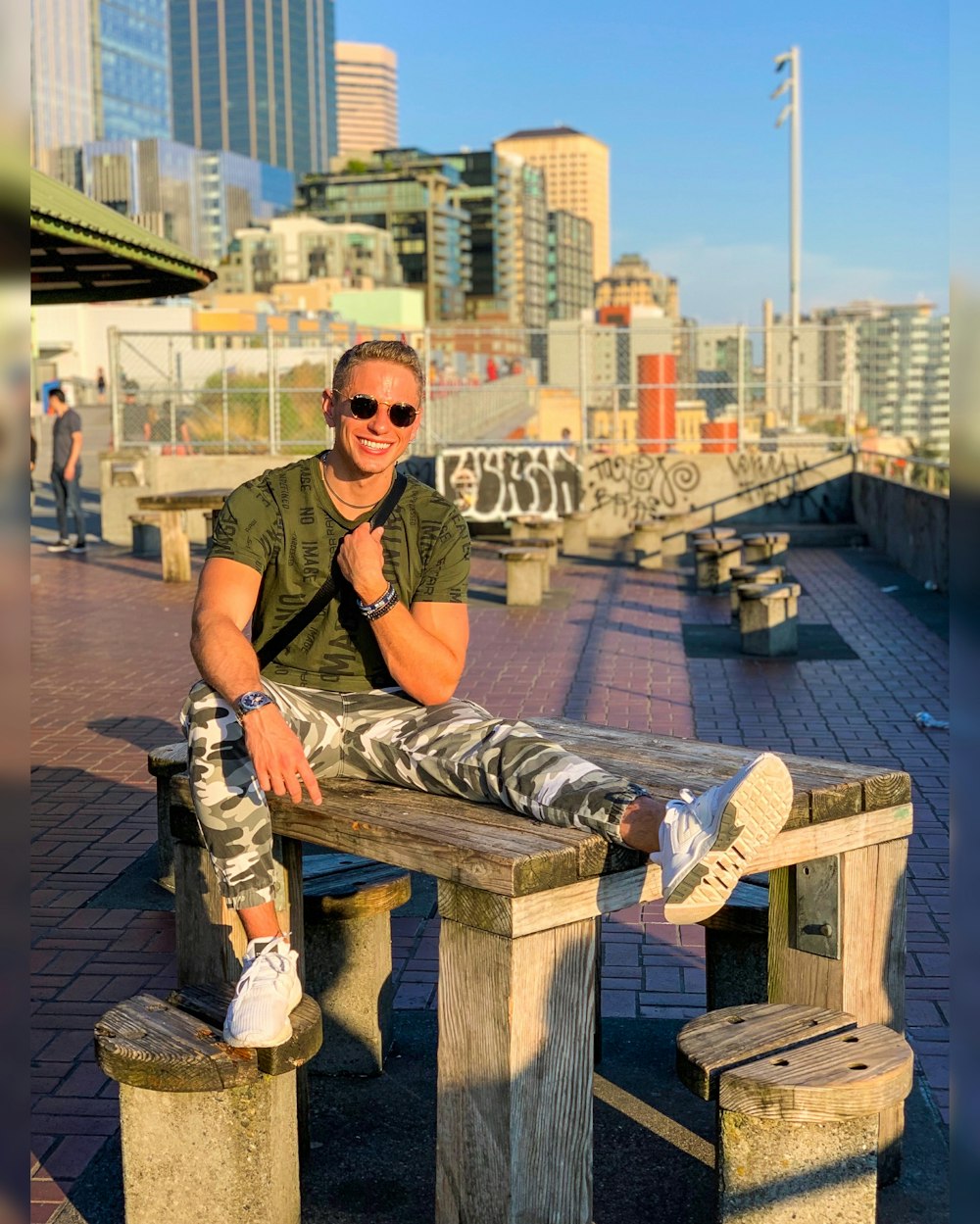 smiling man sitting on brown wooden table