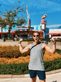 Smiling middle-aged American man holding his slimmer waistline, celebrating weight loss success.